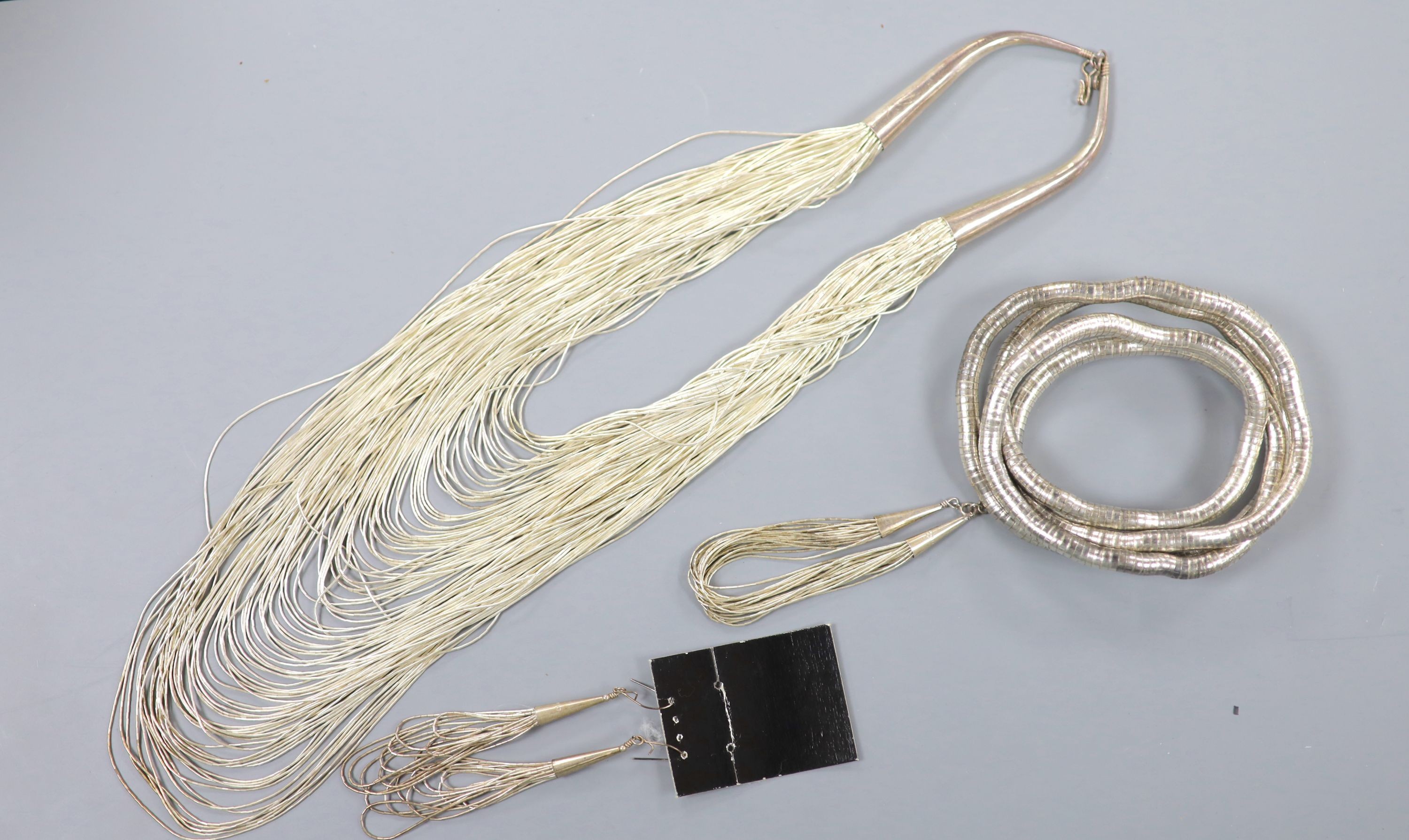 A modern sterling mounted torsade necklace, approx. 58cm, with matching bracelet and earrings and a metamorphic bangle?